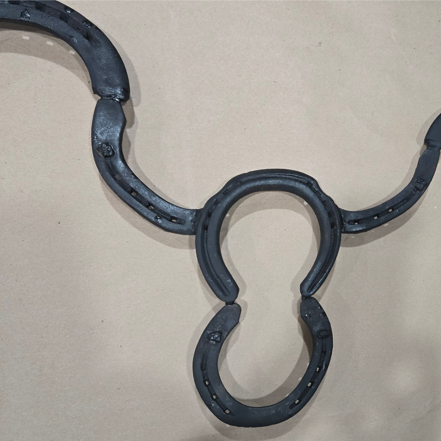 Authentic horseshoes repurposed into a Longhorn wall hanging - Mat Black and Original Rustic finish available.