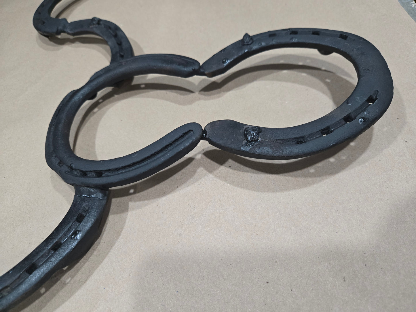 Authentic horseshoes repurposed into a Longhorn wall hanging - Mat Black and Original Rustic finish available.